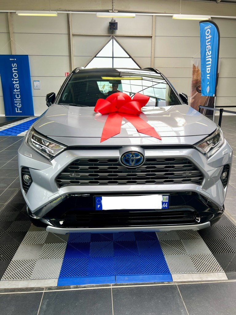 Toyota RAV4 Hybrid with red ribbon